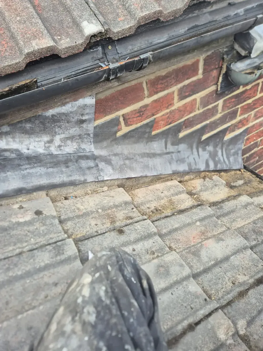 Step lead flashing renewed against brickwork